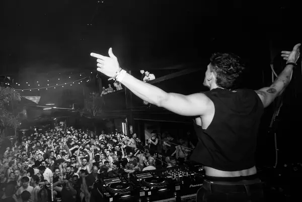 DJ performing to a crowded club floor